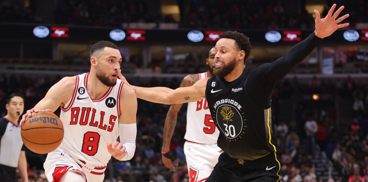 Zach LaVine of the Chicago Bulls drives on Stephen Curry.