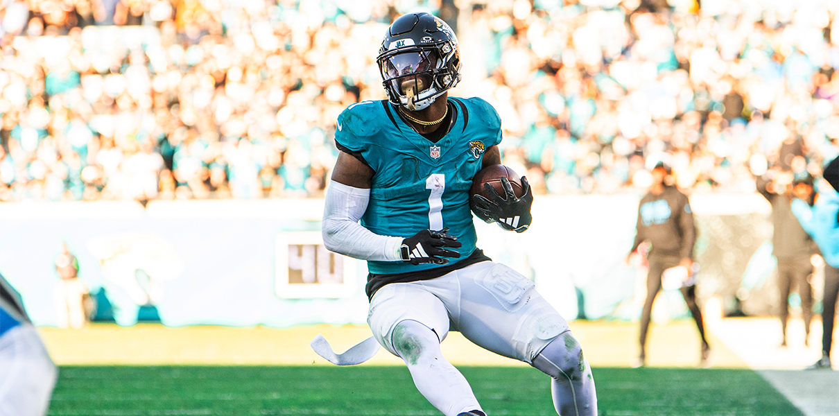 Dec 31, 2023; Jacksonville, Florida, USA; Jacksonville Jaguars running back Travis Etienne Jr. (1) runs the ball against Carolina Panthers linebacker Kamu Grugier-Hill (54) in the fourth quarter at EverBank Stadium. Mandatory Credit: Jeremy Reper-USA TODAY Sports