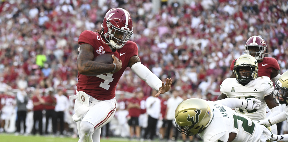 Sep 7, 2024; Tuscaloosa, Alabama, USA;  Alabama Crimson Tide quarterback Jalen Milroe (4) stiff arms South Florida Bulls defensive lineman Rico Watson III (34) as he runs for a touchdown at Bryant-Denny Stadium. Mandatory Credit: Gary Cosby Jr.-Imagn Images